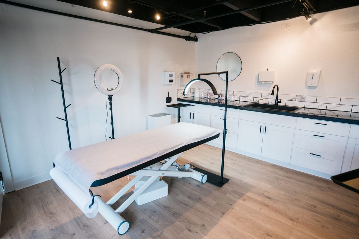 An adjustable treatment table in a bright, modern room
